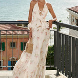 Vestido largo floral con cintura ajustada, escote en pico y cintura alta.