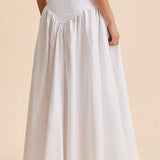 Elegante falda larga blanca con cintura alta y botones de patchwork.