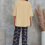 Conjunto elegante de top asimétrico y pantalón ancho con estampado floral para mujer