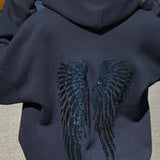 Sudadera informal con estampado de alas y lentejuelas.