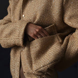 Chaqueta de lentejuelas con cuello alto y bolsillos.