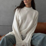 Blusa de punto asimétrica con flecos y cuello redondo