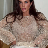 Elegante blusa de lentejuelas con mangas largas en punto.