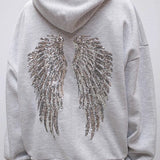 Sudadera informal con estampado de alas y lentejuelas.
