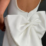 Elegante vestido de noche con lazo y corte entallado.