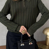 Blusa holgada con cuello polo jacquard y mangas largas.
