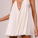 Vestido de noche sexy con detalle de cadena y espalda abierta pronunciada.