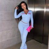 Conjunto de dos piezas: sudadera corta con capucha y estampado de letras y pantalones ajustados.