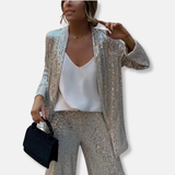 Conjunto de mujer: Chaqueta de lentejuelas estructurada y pantalones anchos de cintura alta.