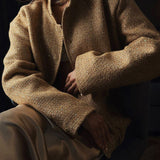 Chaqueta de lentejuelas con cuello alto y bolsillos.