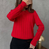 Blusa holgada con cuello polo jacquard y mangas largas.
