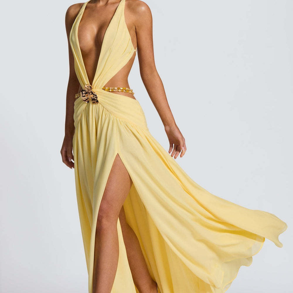 Vestido largo sin espalda con abertura, escote en V profundo, cuello halter y lazo.