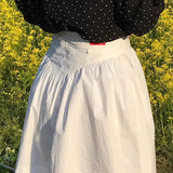 Falda mini juvenil vintage de talle alto, plisada y estampado de tulipanes.