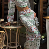 Conjunto de dos piezas compuesto por un crop top estampado de manga larga y cuello redondo y una falda entallada con abertura.