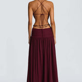 Vestido largo sin espalda con abertura, escote en V profundo, cuello halter y lazo.