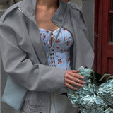 Chaqueta entallada con cuello alto y mangas largas.