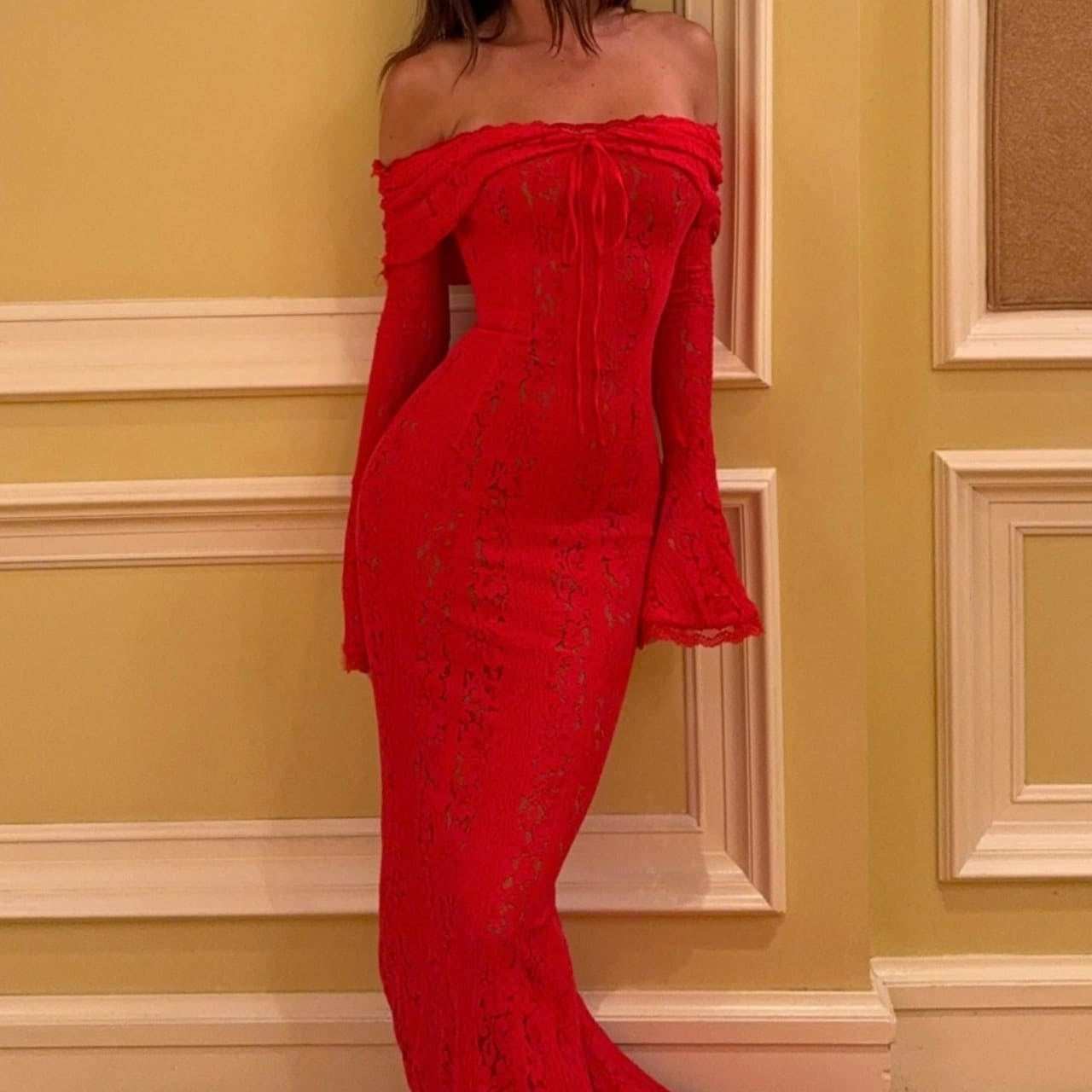 Elegante vestido largo con hombros descubiertos, mangas acampanadas de encaje y cola.