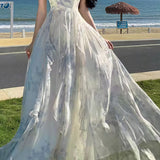 Vestido largo fluido con tirantes finos y volantes con estampado floral