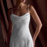 Vestido de noche con tirantes finos y perlas blancas.