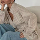 Blusa de rayas con escote en pico y cintura asimétrica con lazo, manga larga