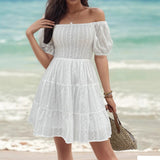 Vestido de mujer con hombros descubiertos, corpiño fruncido, mangas abullonadas y falda con volantes.