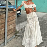 Conjunto de dos piezas para mujer: encaje transparente, top con hombros descubiertos y falda larga de cintura alta con volantes.