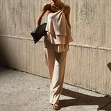 Conjunto de dos piezas para mujer: Top asimétrico con volantes y pantalón largo fluido.