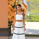 Conjunto de dos piezas para mujer: Top tipo bustier ajustado, falda larga con volantes y tejido ligero.