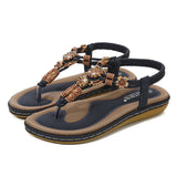 Sandalias planas de mujer – Estilo boho chic – Cuentas de madera – Tira trenzada en el tobillo