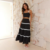 Conjunto de dos piezas para mujer: Top tipo bustier ajustado, falda larga con volantes y tejido ligero.
