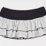 Minifalda ajustada con volantes, patchwork de lunares y bloques de color.