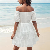 Vestido de mujer con hombros descubiertos, corpiño fruncido, mangas abullonadas y falda con volantes.