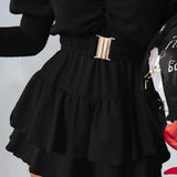 Vestido de mujer con hombros descubiertos, cinturón ancho, mangas asimétricas y falda con volantes.