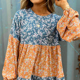 Blusa de gasa con estampado floral, cuello redondo y manga larga.