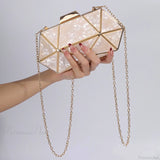 Bolso de hombro de acrílico y metal adornado con diamantes.