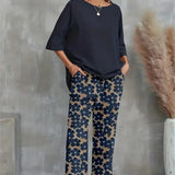 Conjunto elegante de top asimétrico y pantalón ancho con estampado floral para mujer