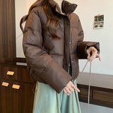 Chaqueta corta acolchada para mujer, con cremallera frontal y botones a presión, cuello alto.