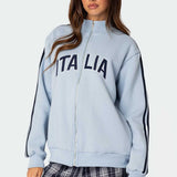 Sudadera holgada de cuello alto con cierre de cremallera y letras bordadas.
