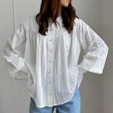 Blusa blanca de algodón jacquard con cuello alto
