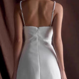 Vestido de noche con tirantes finos y perlas blancas.