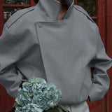 Chaqueta entallada con cuello alto y mangas largas.