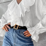 Blusa de jersey de algodón con volantes y escote en pico
