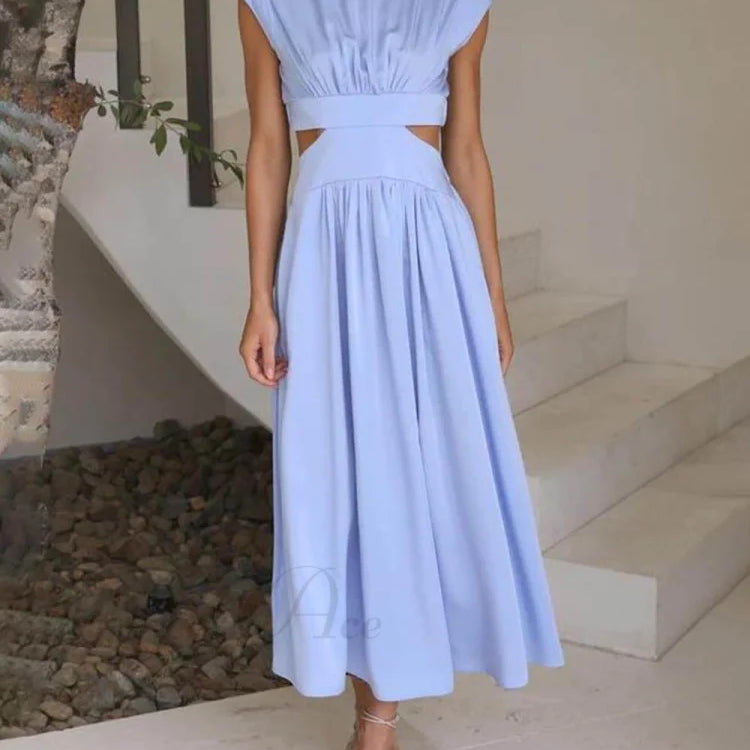 Encantador vestido midi de vacaciones con corte en la cintura y bolsillos.