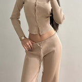 Conjunto sexy de dos piezas de malla, ajustado y abotonado, con mangas largas y cintura baja.