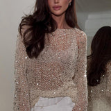 Elegante blusa de lentejuelas con mangas largas en punto.