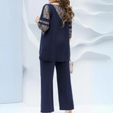 Conjunto de dos piezas para mujer: túnica holgada de encaje y pantalón recto.