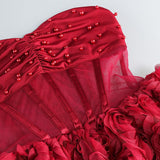 Vestido de noche sin tirantes con perlas y volantes