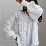Blusa blanca de algodón jacquard con cuello alto