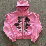 Sudadera con cremallera, bordado y pedrería.