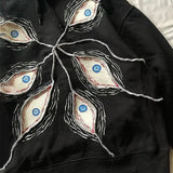 Sudadera gótica oscura con diseño de mal de ojo y hip-hop.